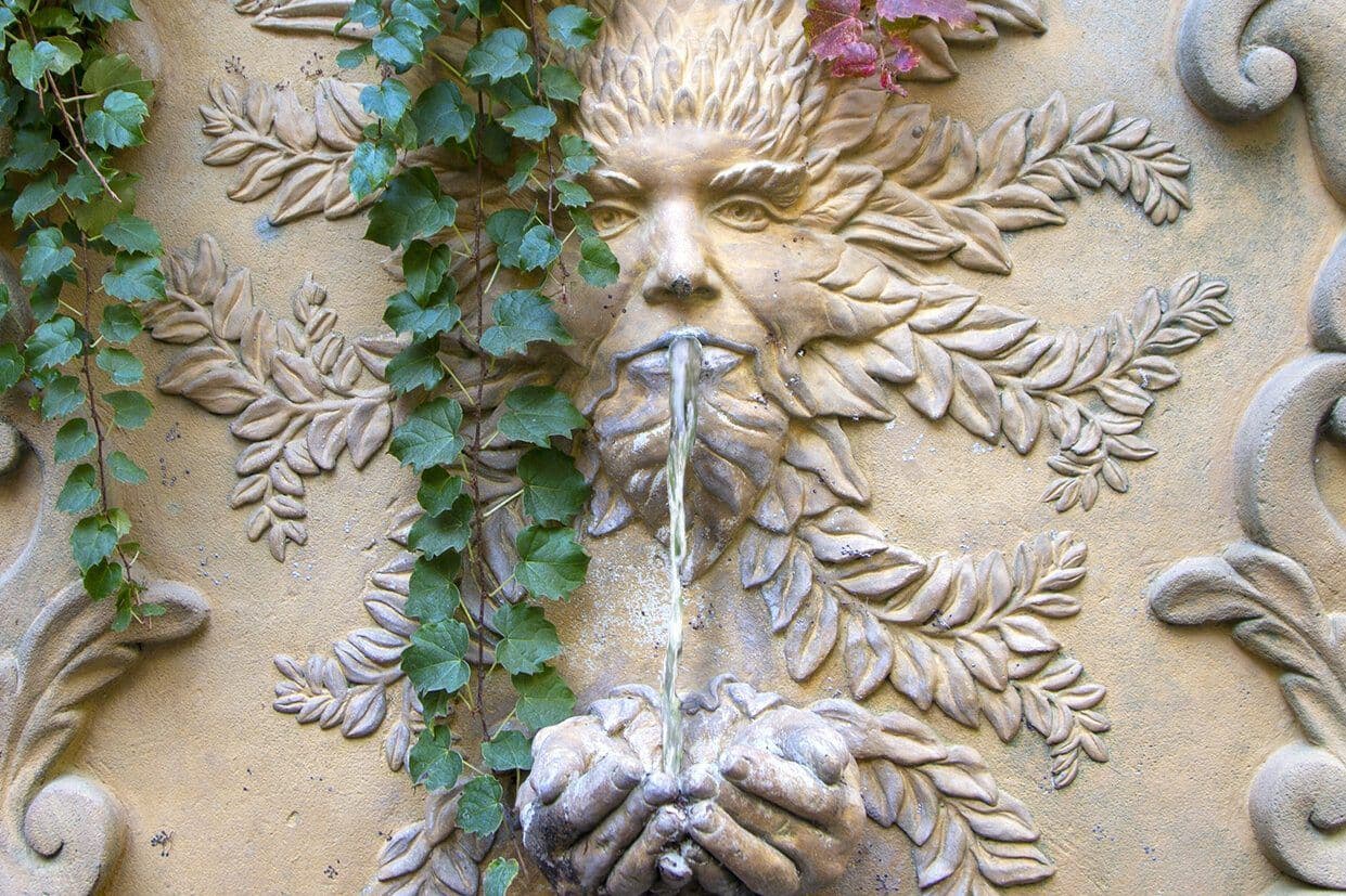 The ivy covered fountain in the courtyard