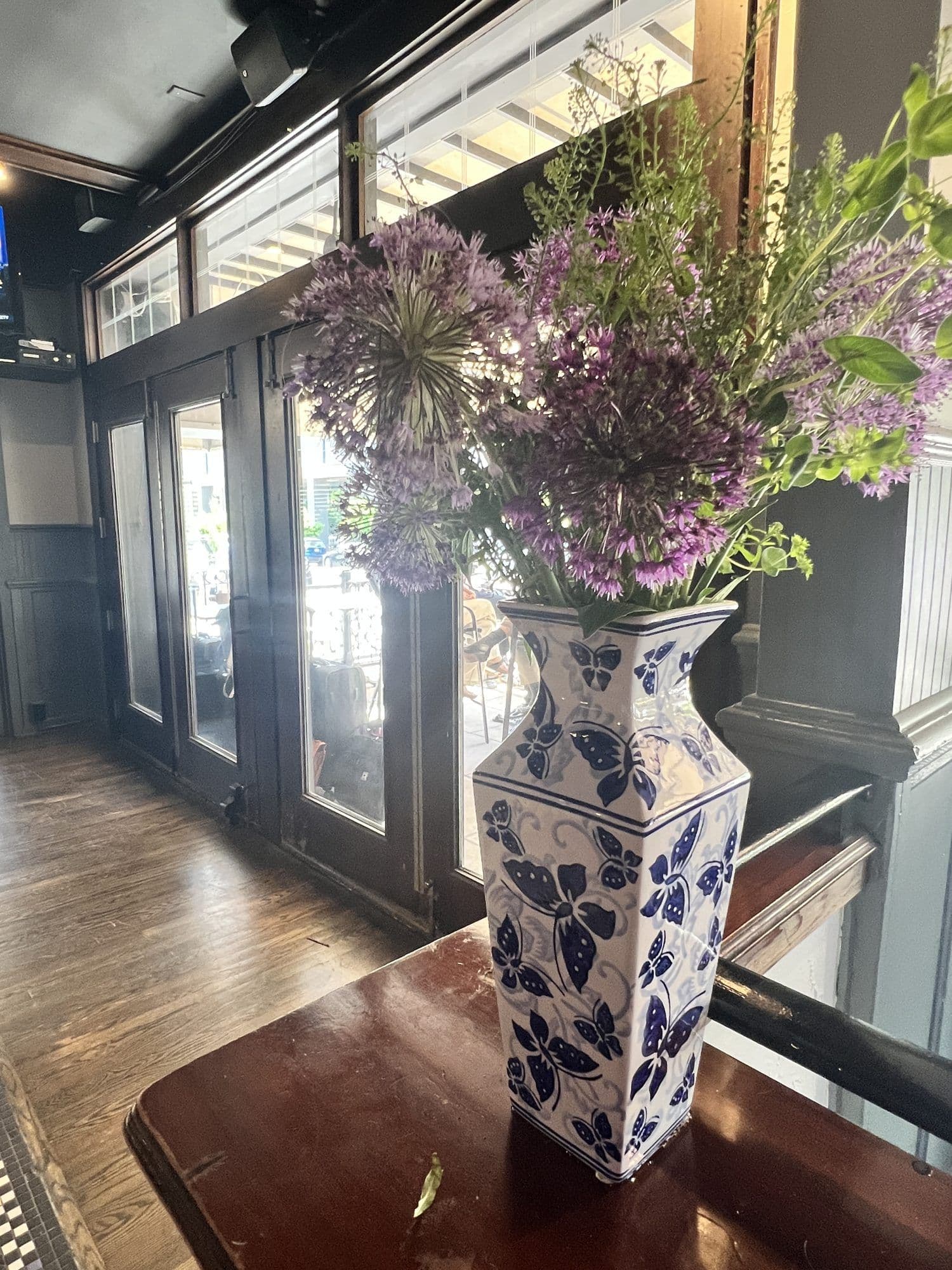 Flowers in a blue and white vase at the courtyard entrance