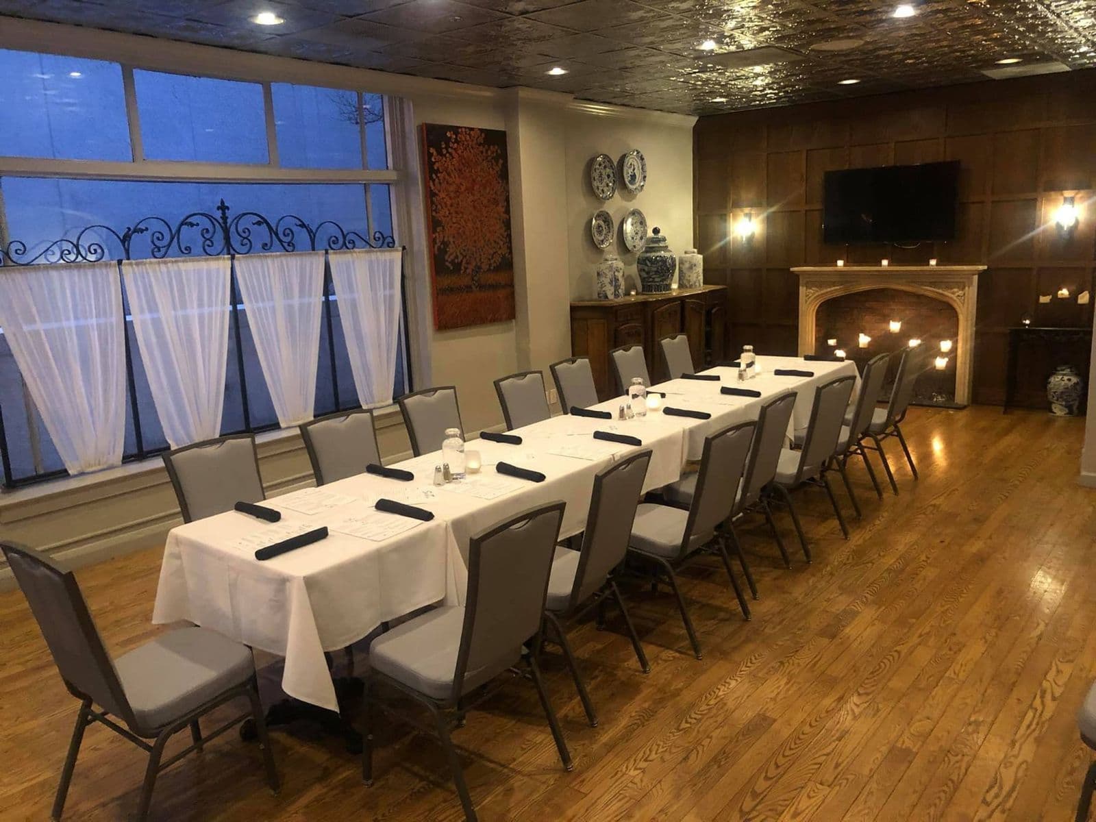 The Gables Room with a long table by the fireplace