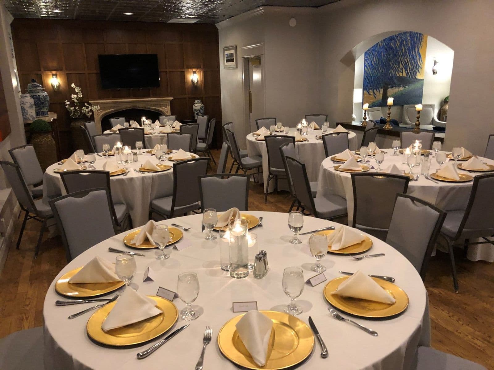 The Gables Room set with round tables and gold chargers
