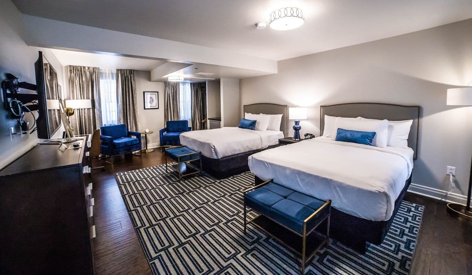 Premium Double Queen room with two queen beds and a seating area