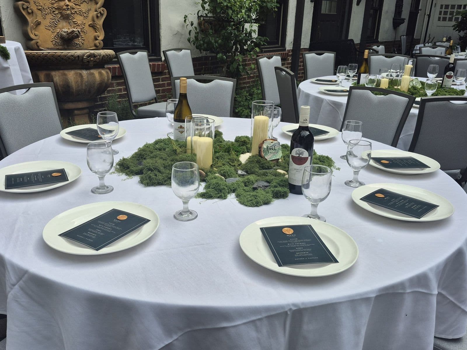 A wedding reception table with greenery